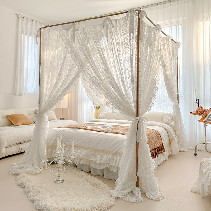 Sheer lace bed canopy on a cozy bed with natural cotton bedding in a bright, elegant bedroom