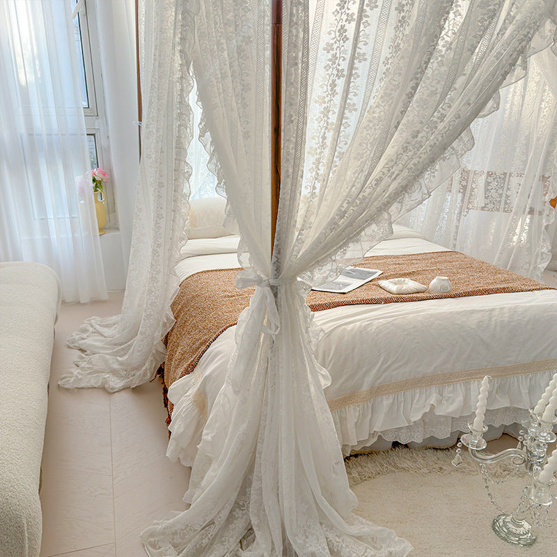 Sheer lace bed canopy over a cozy pure cotton bed in a bright, elegant bedroom decor