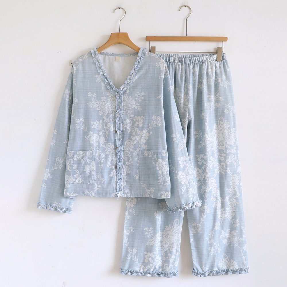 Soft blue ruffled cotton pajama set with floral print hanging on wooden hangers