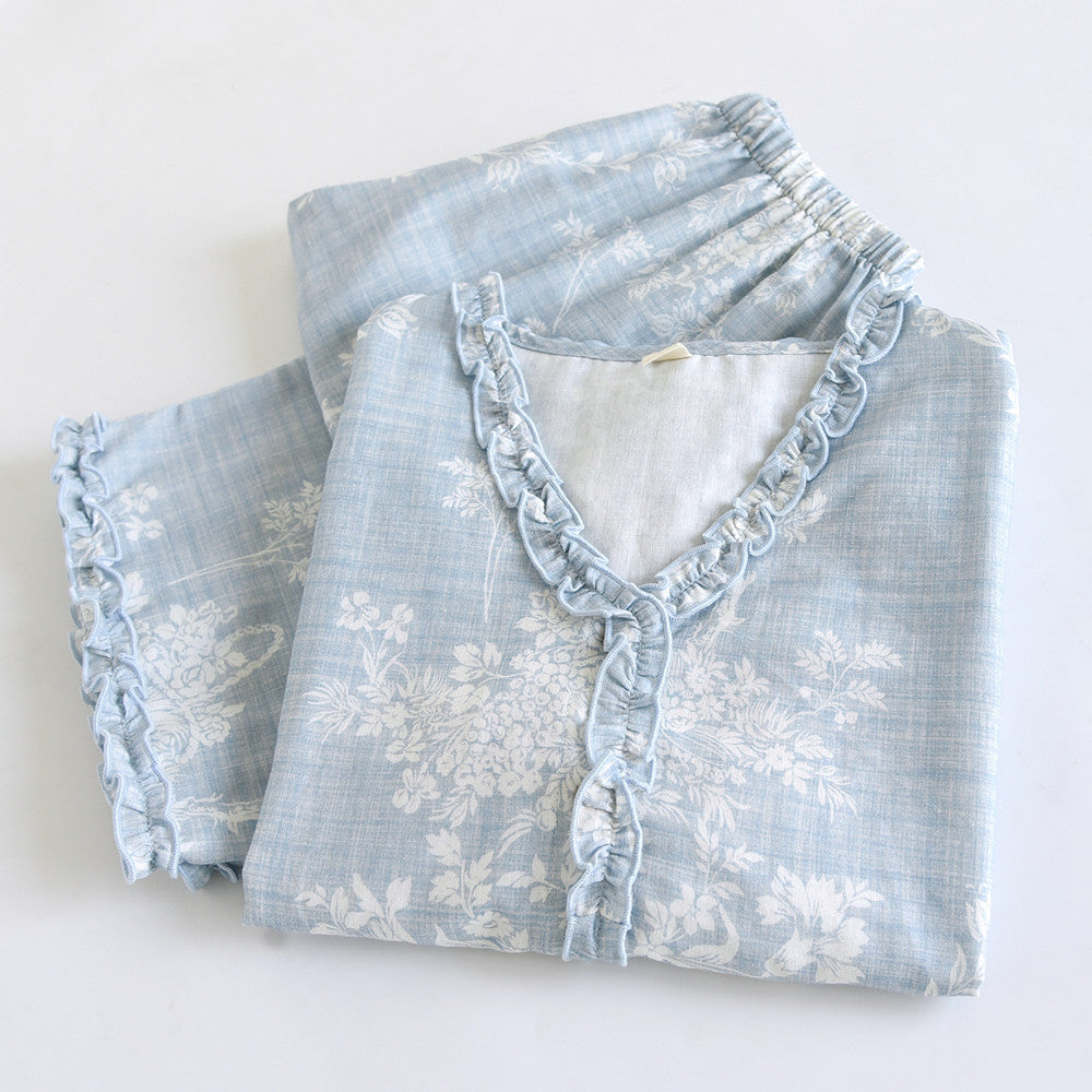 Soft blue ruffled floral cotton pajama set with white botanical print, neatly folded