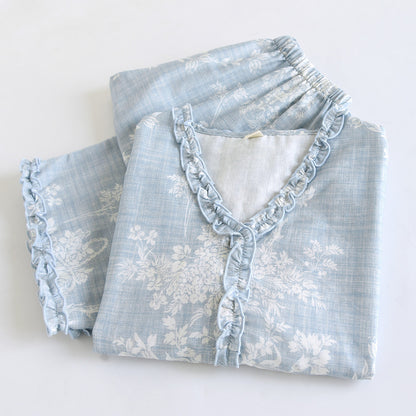 Soft blue ruffled floral cotton pajama set with white botanical print, neatly folded