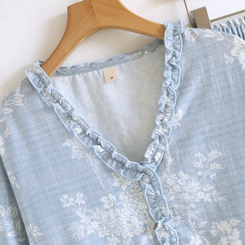 Soft blue cotton pajama top with ruffled V-neck and white floral print on hanger