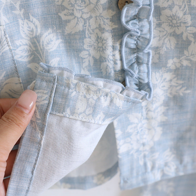 Close-up of soft blue floral cotton pajama set with ruffled trim and hidden seam detail