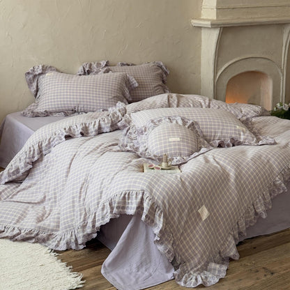 Lavender plaid ruffled duvet cover set styled on bed with matching pillowcases, soft cotton muslin
