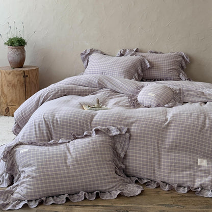 Lavender plaid duvet cover set with ruffled edges and lace trim, displayed in a rustic styled room