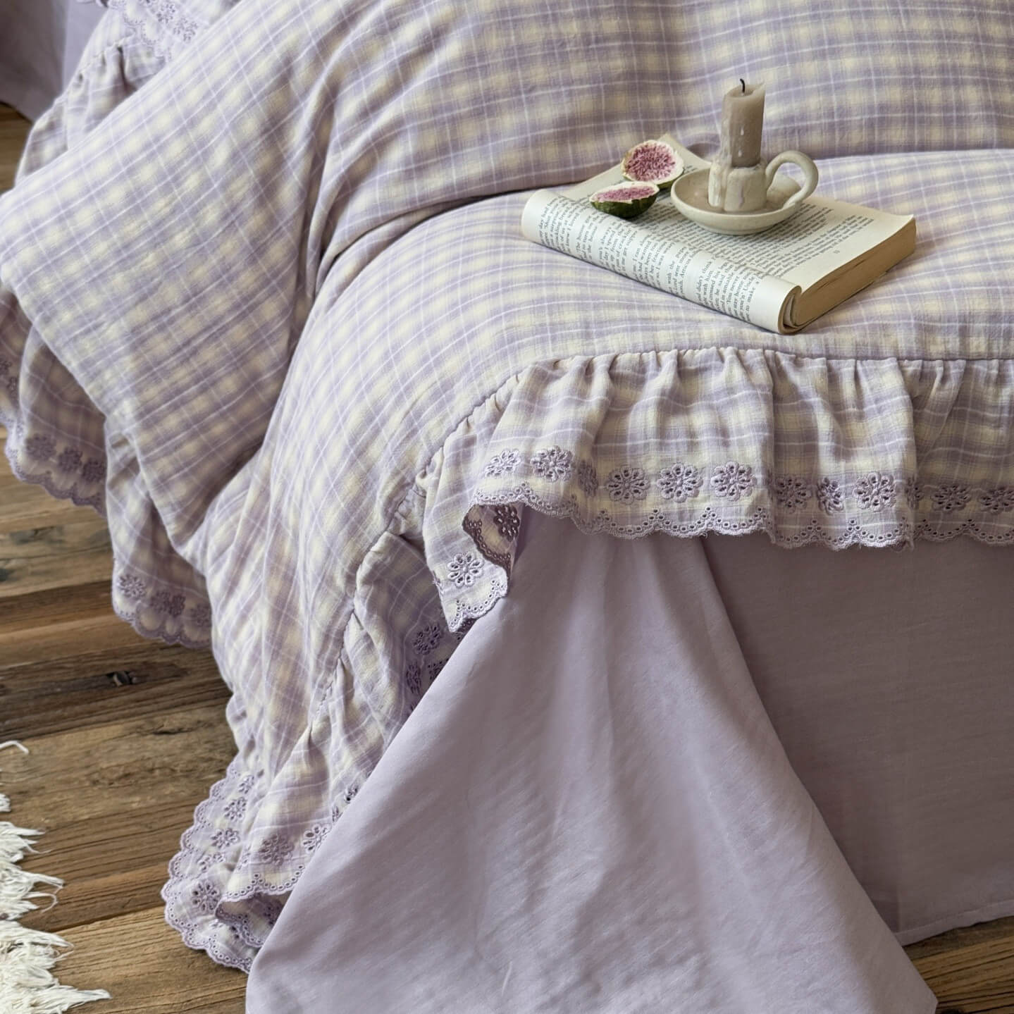 Detailed shot of lace-trimmed ruffle on lavender plaid ruffled duvet cover, soft cotton muslin lavender solid flat sheet