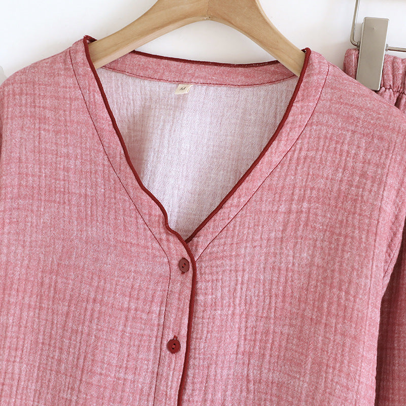 Soft pink cotton gauze women's pajama set with v-neck and button front on hanger