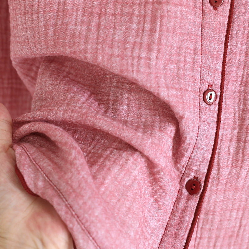 Soft pink cotton gauze women's pajama top with button details, close-up view