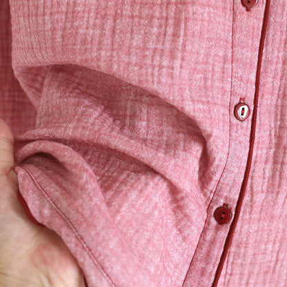 Soft pink cotton gauze women's pajama top with button details, close-up view