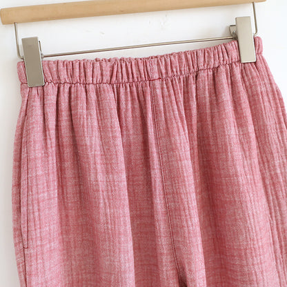Soft pink cotton gauze women's pajama pants with elastic waistband, close-up view