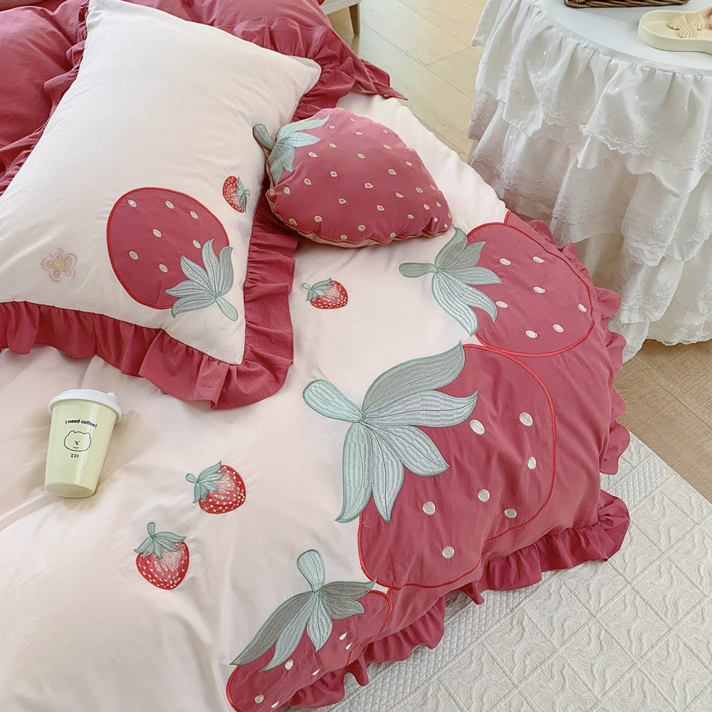 Pink strawberry cotton bedding set with ruffled edges on a bed, StuffedHome sustainable decor