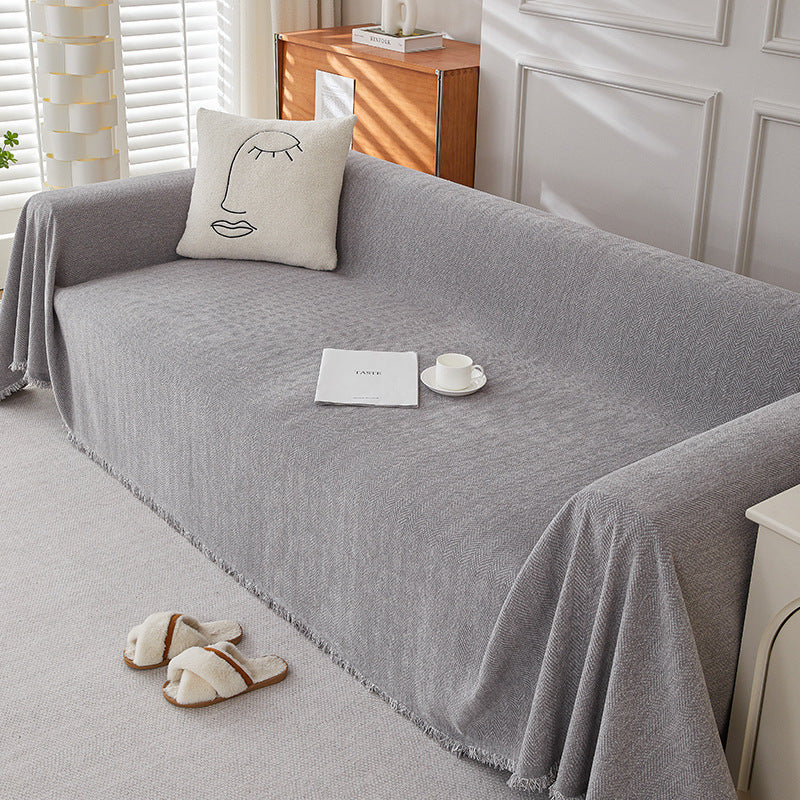 Textured herringbone chenille sofa cover in light grey, decorative pillow, cozy home setting