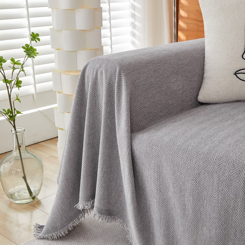 Gray textured herringbone chenille sofa cover in sunlit living room with modern decor