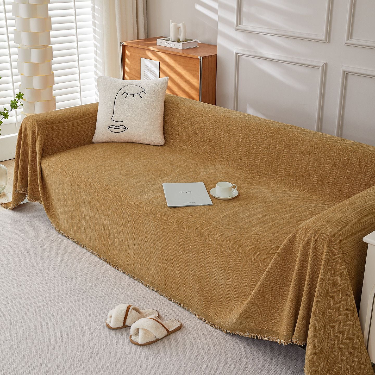 Textured herringbone chenille sofa cover in a cozy living room with decorative pillow and slippers