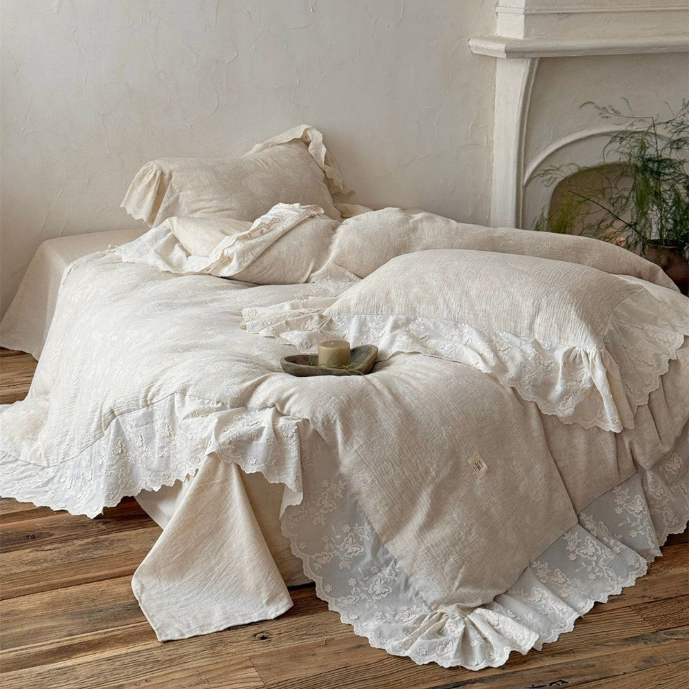 Cozy beige textured linen cotton bedding set with embroidered lace trim on wooden floor