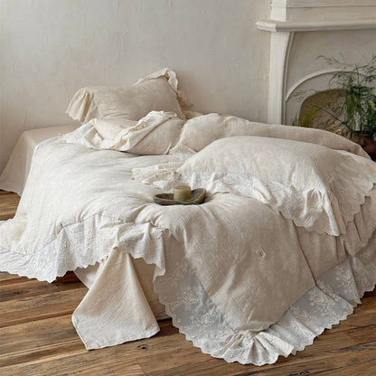 Cozy beige textured linen cotton bedding set with embroidered lace trim on wooden floor