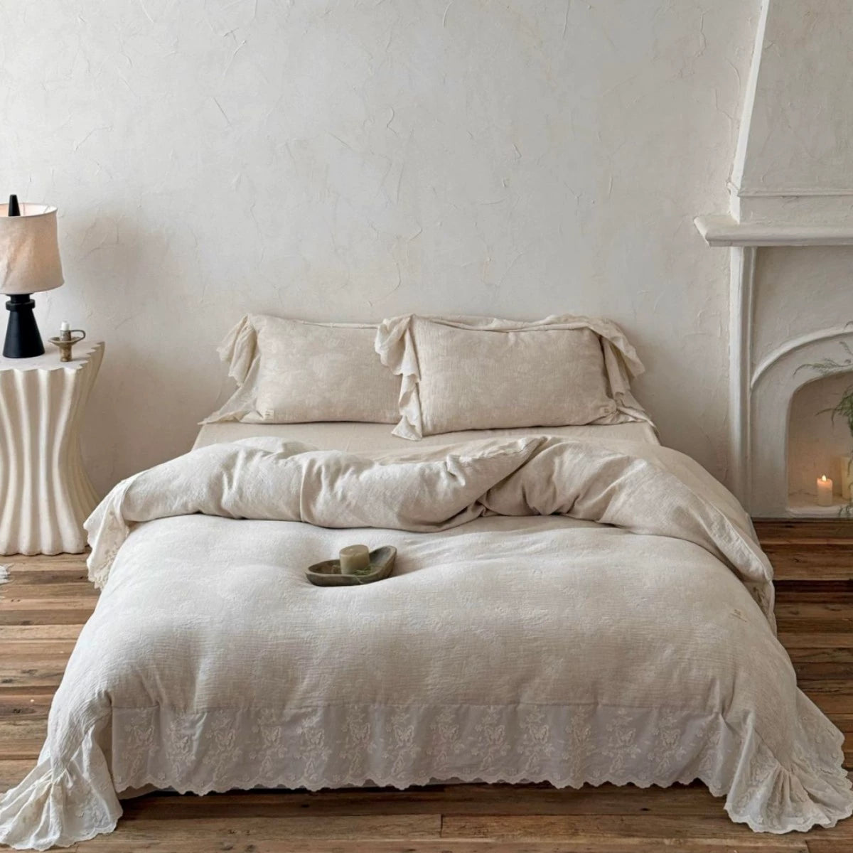 Textured beige linen cotton bedding set with embroidered trim in cozy rustic bedroom