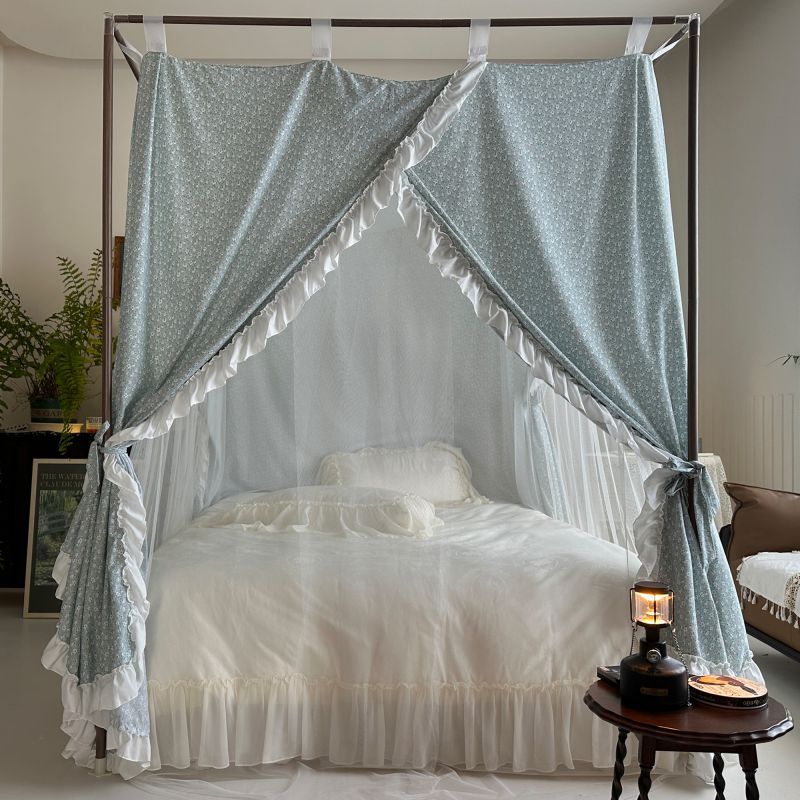 Vintage floral bed canopy with ruffled trim over white bedding in cozy bedroom setting