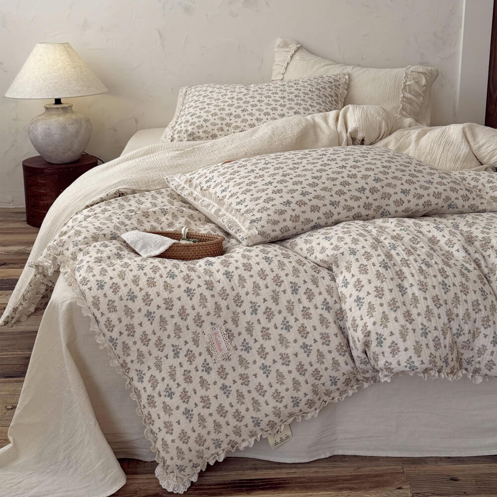 Vintage floral bedding set with delicate lace ruffle trim casually styled on a cottagecore bed with matching ditsy flower pillowcases.