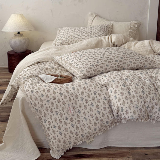 Vintage floral bedding set with delicate lace ruffle trim casually styled on a cottagecore bed with matching ditsy flower pillowcases.