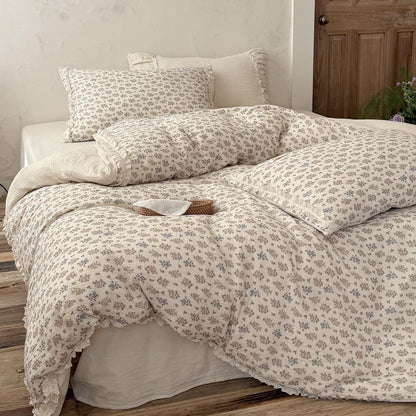 Front view of a beautifully styled cottagecore bed with a lightweight vintage floral comforter and a small decorative rattan basket.
