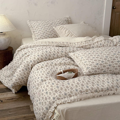 A detailed close-up shot of two rustic pillows with small floral patterns and eyelet lace ruffle trim.