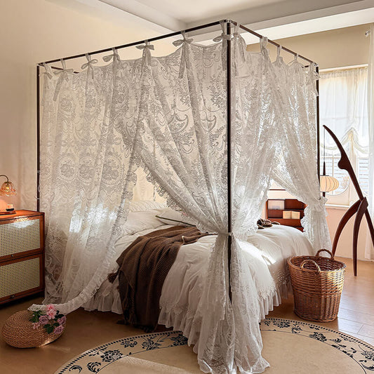 Bedroom with a canopy bed draped in lace curtains, wooden nightstands, and a basket.