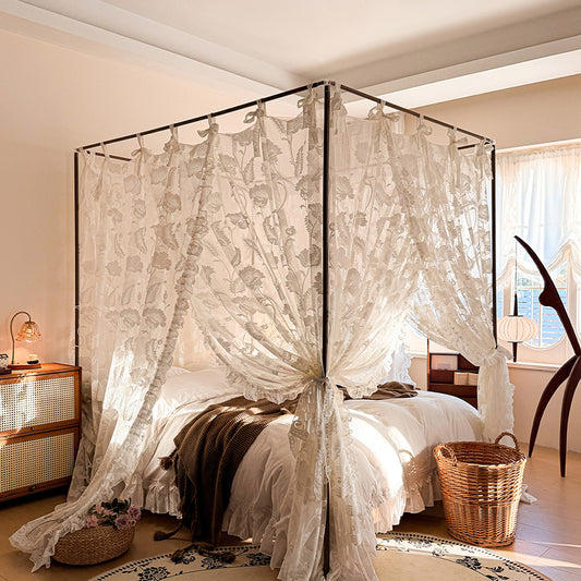 Vintage floral lace canopy curtains on a four-poster bed in a cozy sunlit bedroom