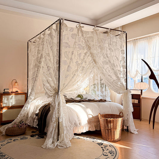 Vintage floral lace canopy curtains on a four-poster bed in a cozy sunlit bedroom