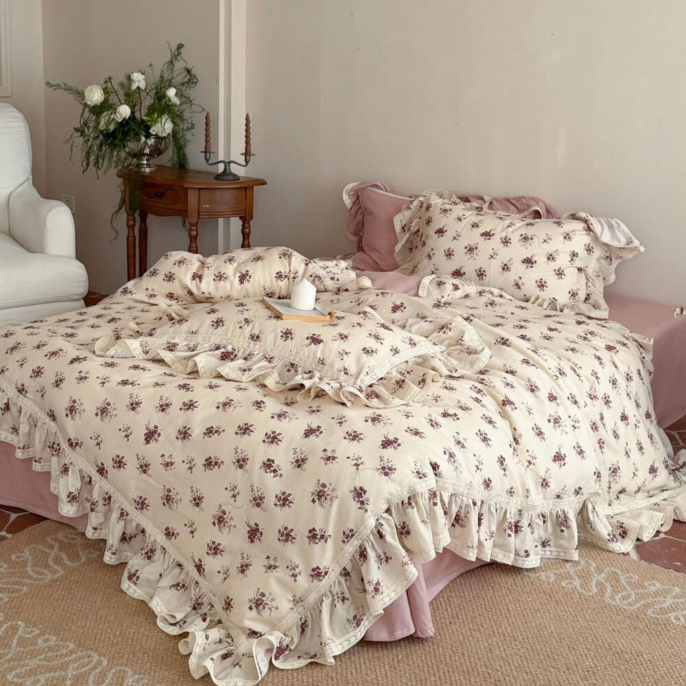 Vintage rose muslin bedding set with delicate lace trim and dusty pink sheets in a cottagecore bedroom setting.