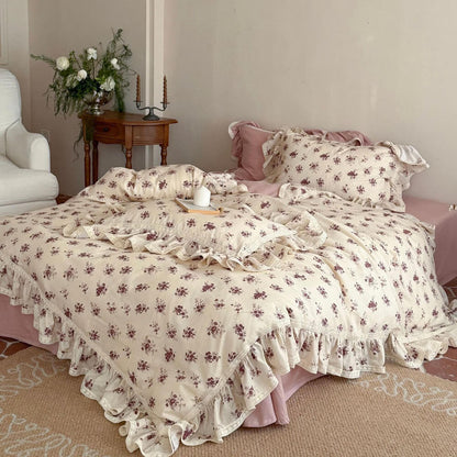 Vintage rose muslin bedding set with delicate lace trim and dusty pink sheets in a cottagecore bedroom setting.