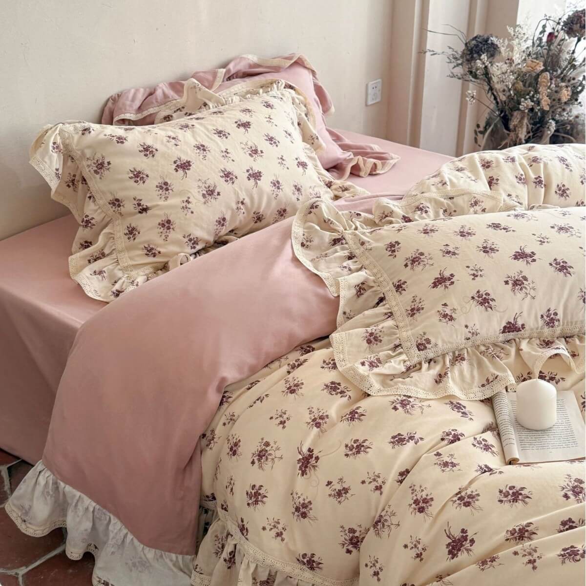 Elegant vintage rose muslin pillowcases with scalloped lace borders paired with solid pink bedding.