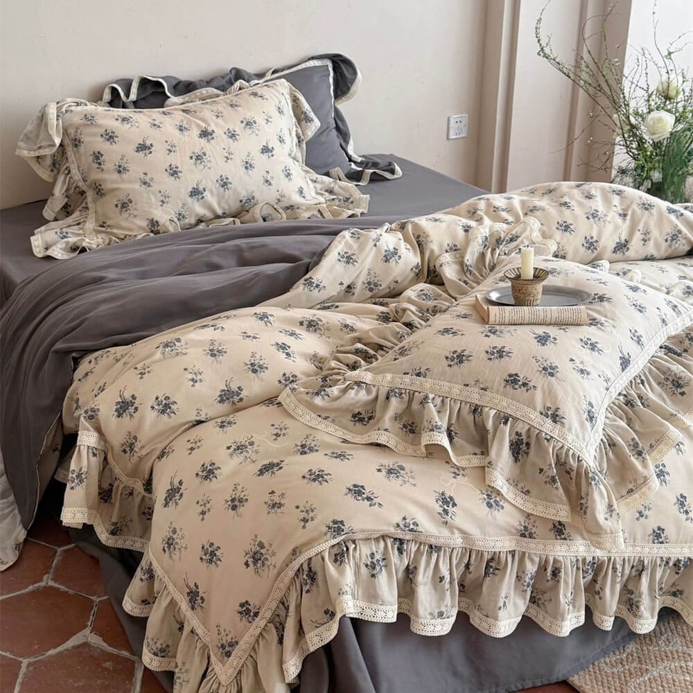 Vintage rose muslin bedding set in a grey colorway featuring dark grey sheets and lace-trimmed floral duvet.