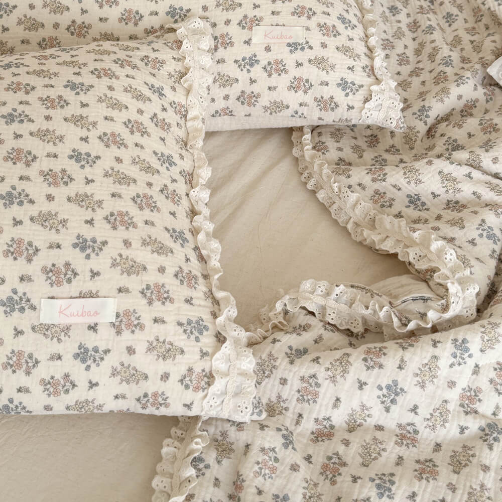 Top-down close-up shot of two cottagecore aesthetic pillows with tiny floral patterns and sweet eyelet lace ruffle trim.