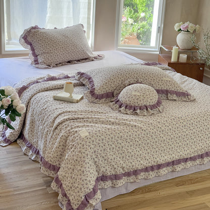 Relaxed cottage bedroom setting with lavender comforter and decor