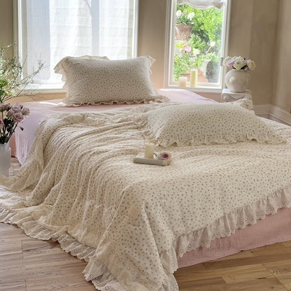 Full bedroom scene featuring the romantic floral cotton comforter in a sunlit room with a bay window, creating a bright and airy summer bedding look.