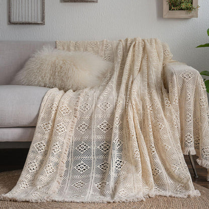Vintage crochet lace sofa cover with tassel trim draped on a beige couch, StuffedHome decor