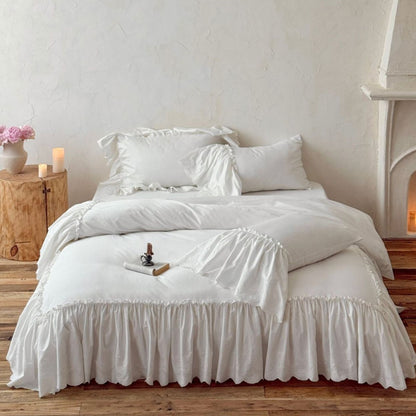White cotton bedding set with ruffled trim on a rustic wooden bed, cozy bedroom decor