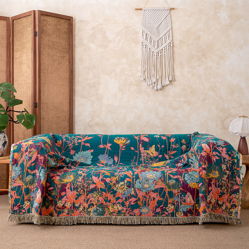 Deep teal reverse side of wildflower garden cotton throw blanket styled on a sofa