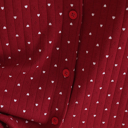 Close-up of red cotton pajama top with white heart print and red buttons