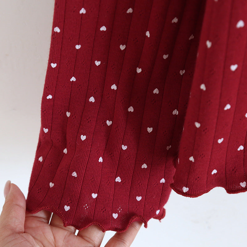 Red cotton pajama sleeve with white heart print and scalloped hem detail