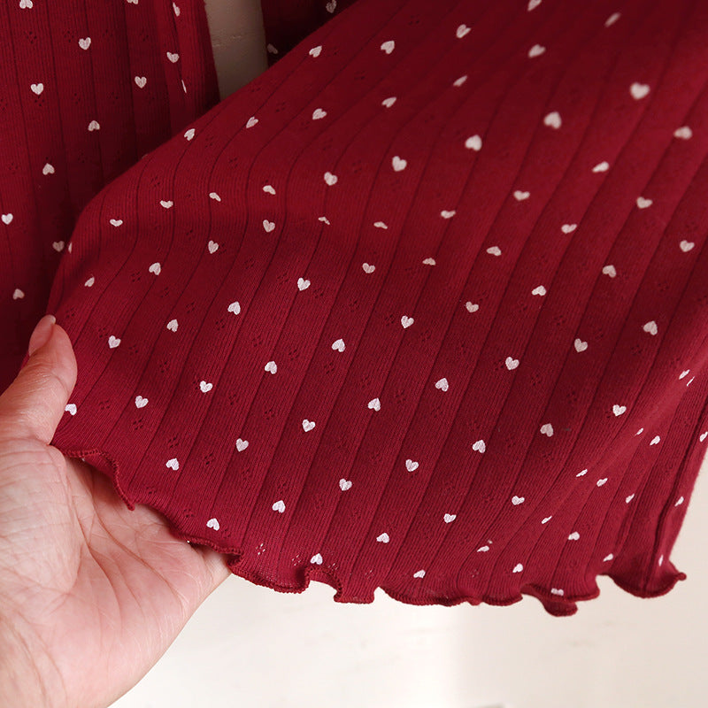 Red cotton pajama set fabric with white heart print and ruffle hem detail