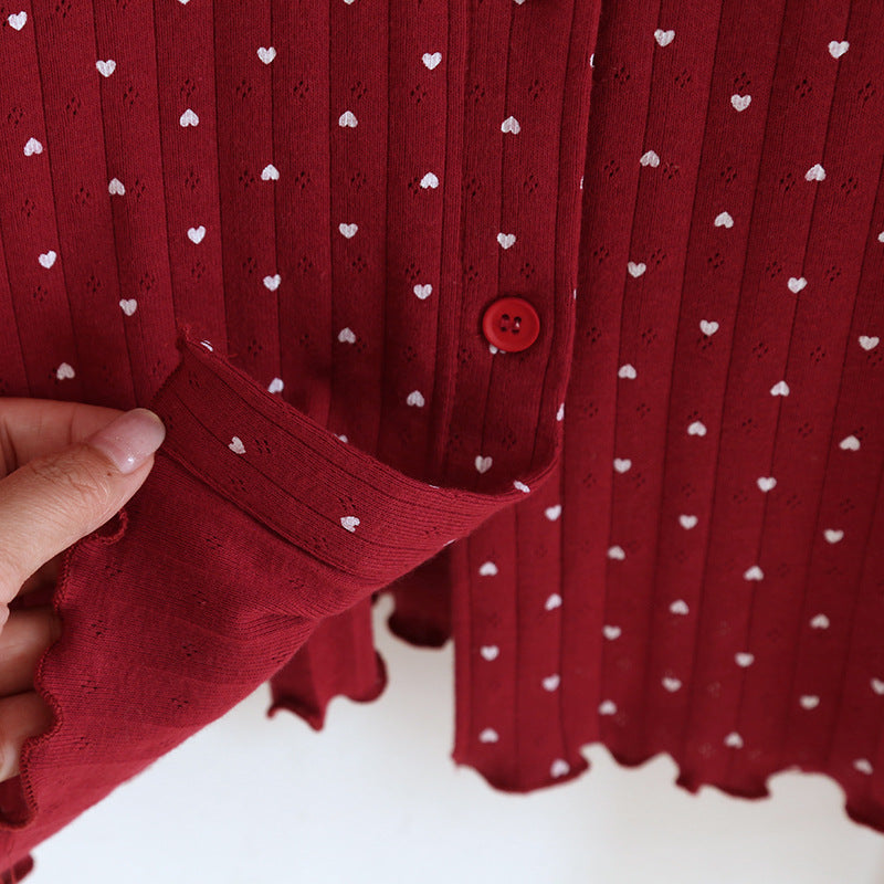 Red cotton pajama top with white heart print, scalloped hem, and button detail