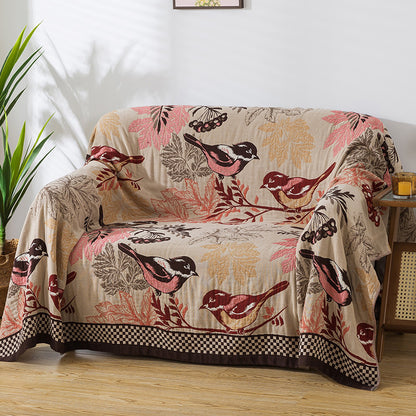 Bird and leaf patterned jacquard blanket used as a sofa cover