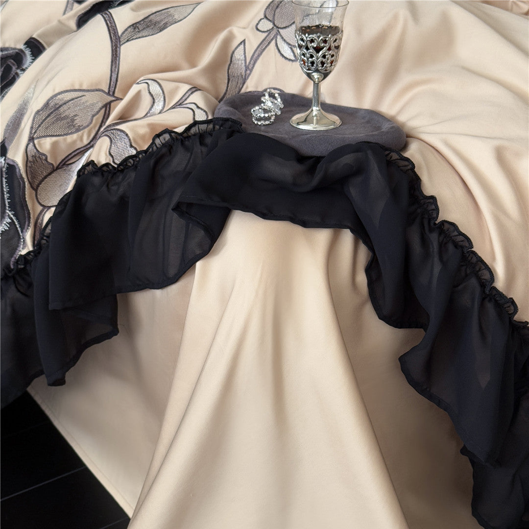 Sheer black ruffle detail on warm taupe duvet corner