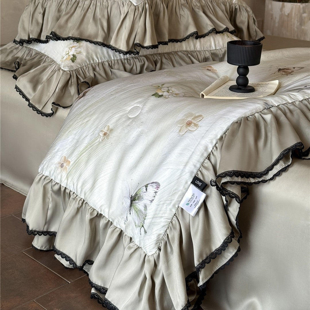 Folded butterfly comforter with tag showing TENCEL™ lyocell material