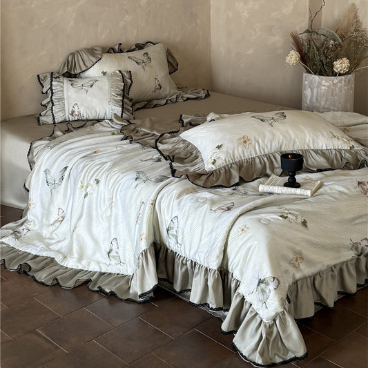 Full bed view of butterfly comforter set with lace-trimmed ruffles