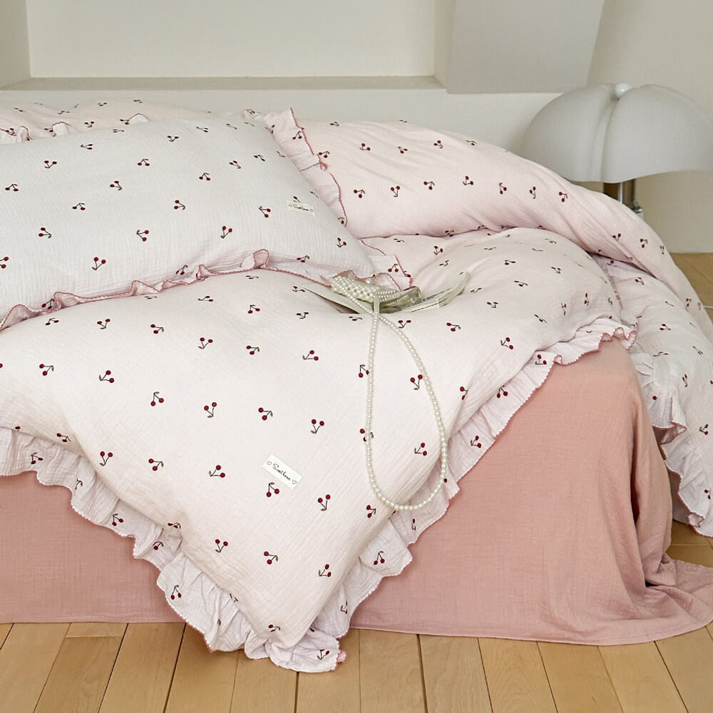 Full view of bed styled with a soft cotton gauze cherry print ruffle duvet cover set.