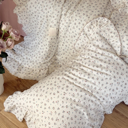 Draped floral comforter in crinkled cotton gauze, showing lace and fabric texture