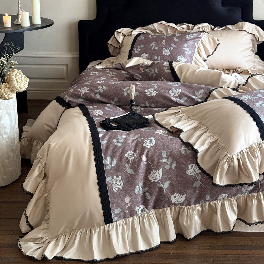 Romantic dusty mauve floral bedding with wide ruffles and black lace